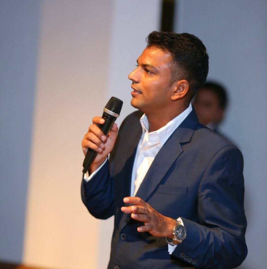 Dr. Avinash Singh speaking on stage